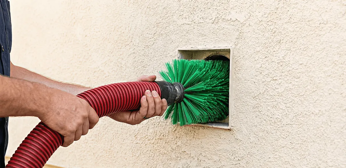 Air duct cleaning brush removing debris from a vent opening in Cambridge, MA
