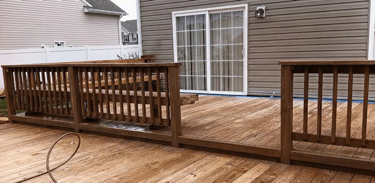 Deck sealing service protecting a backyard wood deck and railings in Cambridge, MA