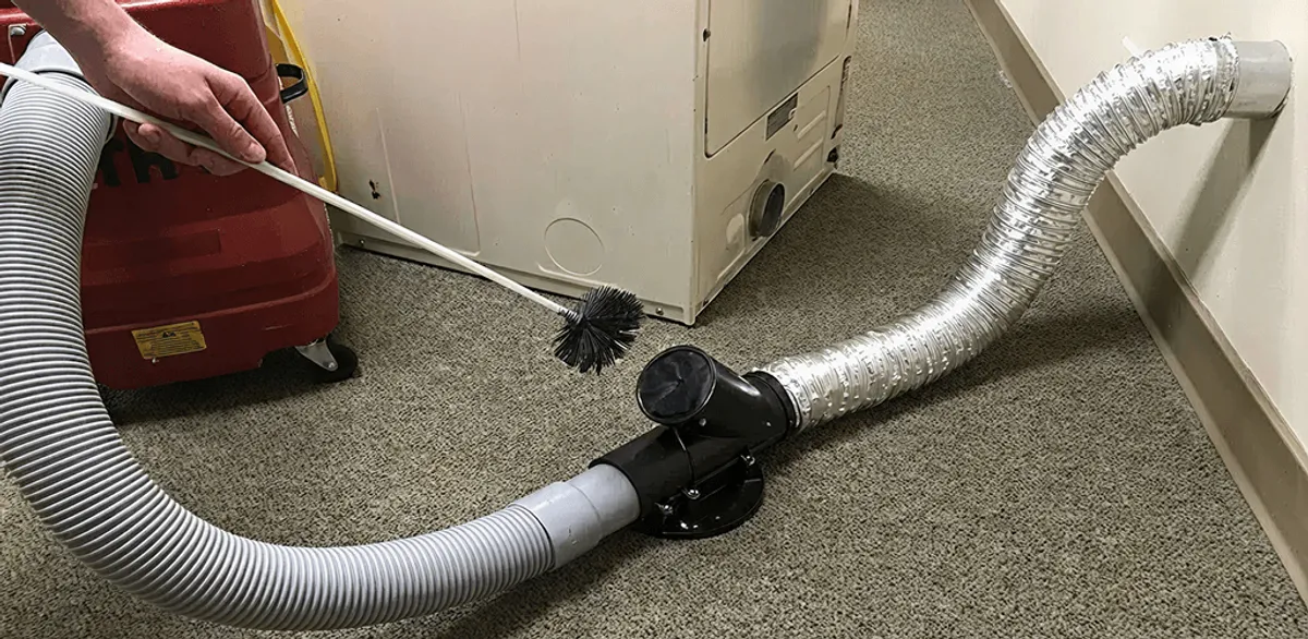 Dryer vent cleaning service removing lint from a dryer duct connection in Cambridge, MA