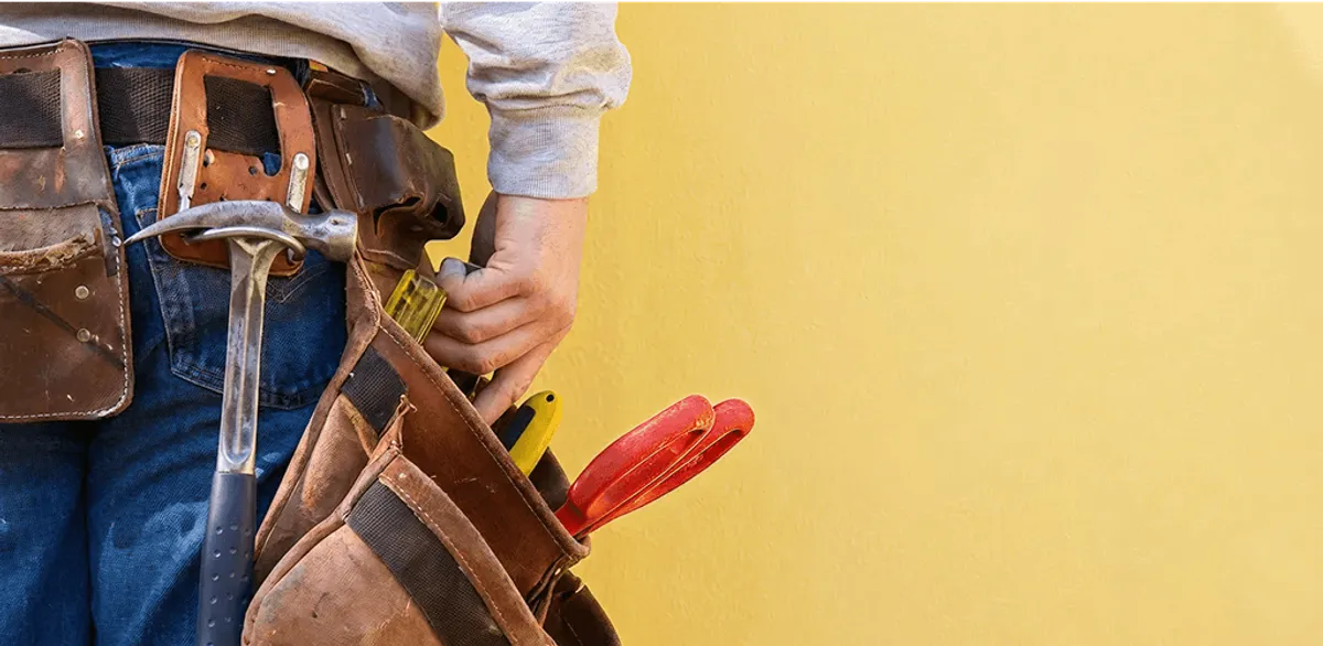 Handyman with tool belt ready for home repairs and maintenance in Cambridge, MA