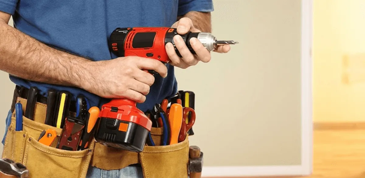 Handyman holding a power drill for home repairs and installations in Cambridge, MA