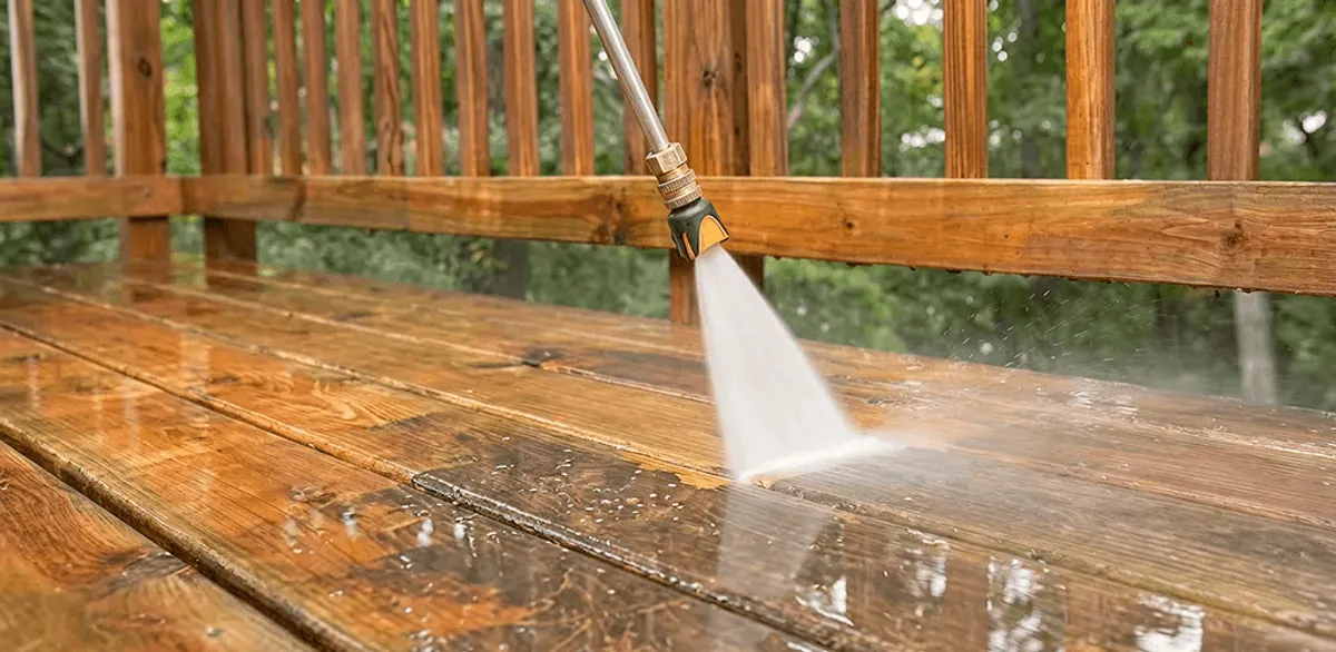 Pressure washing a wood deck to remove dirt and buildup in Cambridge, MA