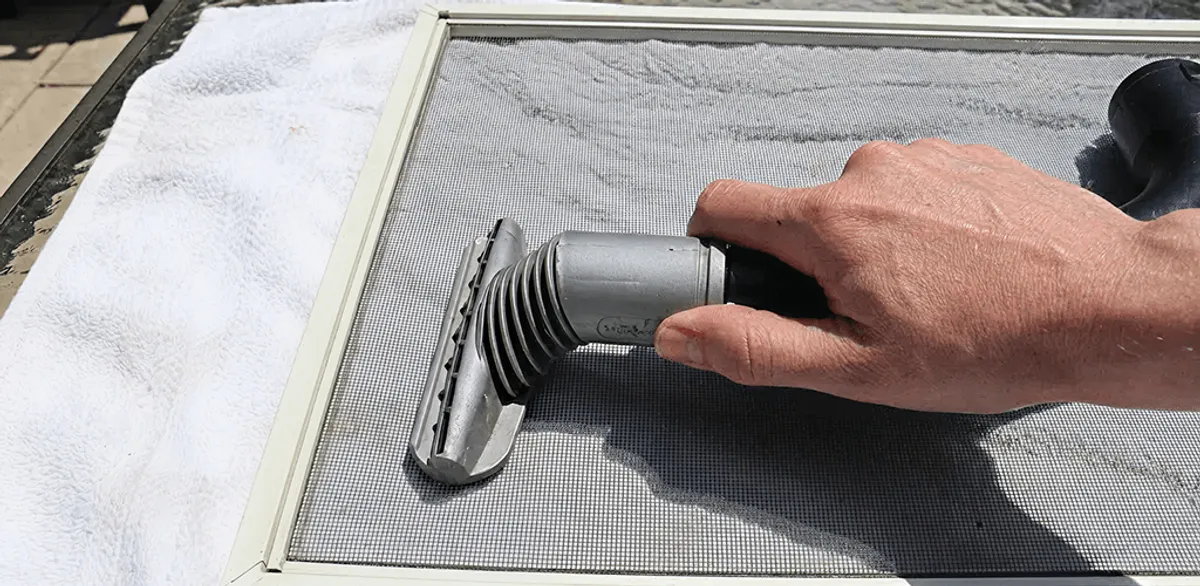 Window screen repair cleaning and fixing a damaged screen mesh in Cambridge, MA